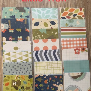 May include: A set of 12 patterned paper sheets with a woodland theme. The papers feature various designs, including owls, butterflies, trees, stars, and geometric patterns. The papers are perfect for scrapbooking, card making, and other paper crafts.