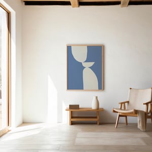 May include: A framed wall art print featuring an abstract composition of stacked, smooth, light beige organic shapes set against a solid blue background. The artwork is displayed in a light-toned wooden frame, showcasing a balanced, geometric design.
