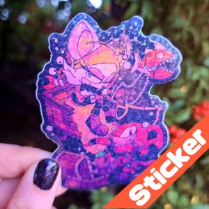 May include: Holographic sticker with a cartoon illustration of Sonic the Hedgehog characters. The sticker has a glittery, iridescent finish and the word "Sticker" in an orange banner. The design is set against a dark background.