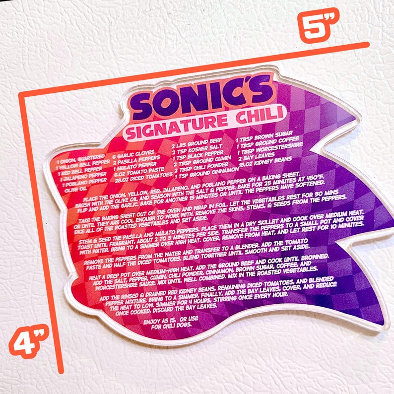 May include: A recipe card for Sonic's Signature Chili, measuring approximately 12.7 cm by 10.2 cm. The card has a starburst design with a purple and red checkered pattern. The recipe includes ingredients and instructions.