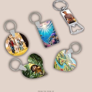 May include: Collection of keychains with various designs. Includes a round keychain with a family and dog, a rectangular underwater scene, a bottle opener with a person, a heart-shaped keychain with a cartoon character, and a heart-shaped keychain with a rainbow.