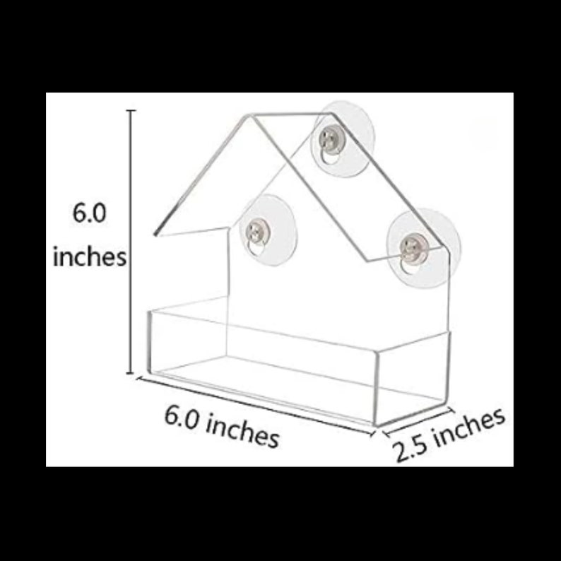 May include: A clear plastic bird feeder shaped like a house with three suction cups. The feeder measures 15.2 cm wide, 15.2 cm tall, and 6.4 cm deep.