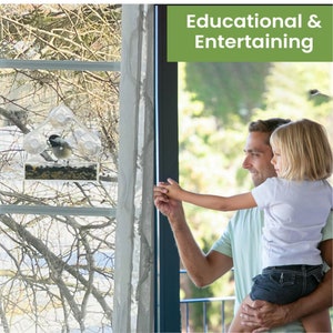 May include: A father and child watch birds at a window feeder. The feeder is attached to the window with suction cups. The feeder is clear plastic and has a small bird inside. The text "Educational & Entertaining" is displayed in green at the top of the image.