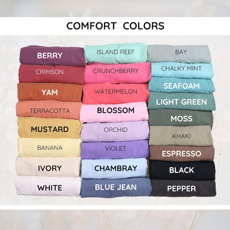 May include: A color chart titled COMFORT COLORS displaying folded t-shirts in various shades including berry, crimson, yam, terracotta, mustard, banana, ivory, white, island reef, crunchberry, watermelon, blossom, orchid, violet, chambray, blue jean, bay, chalky mint, seafoam, light green, moss, khaki, espresso, black, and pepper.