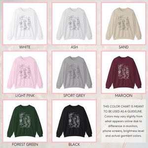 May include: Color chart showing ten different color options for a sweatshirt with a floral design and the word "remarkable" printed on the front. Colors include white, ash, sand, light pink, sport grey, forest green, black, and maroon.