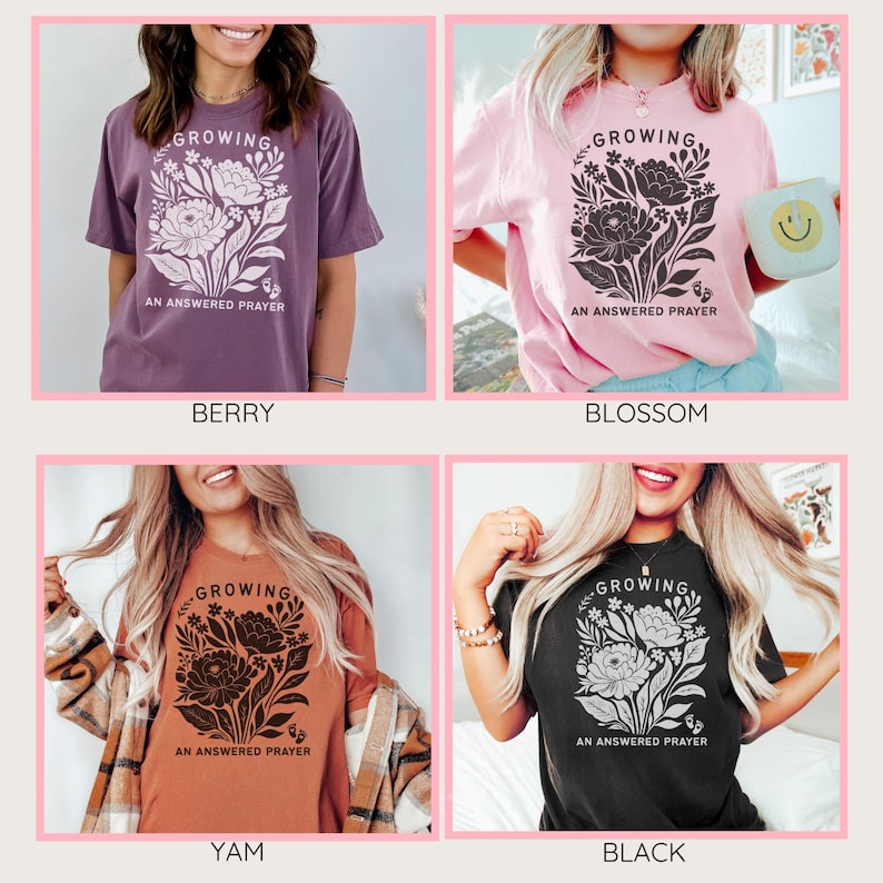 May include: Four short-sleeve t-shirts in berry, blossom, yam, and black colors. Each shirt features a graphic of a floral bouquet with the text "GROWING AN ANSWERED PRAYER" and small baby footprints at the bottom of the design.