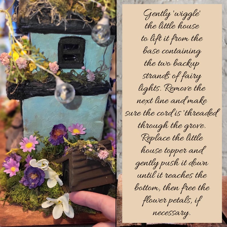 May include: A light blue miniature house with a dark roof, decorated with moss, small artificial flowers, and fairy lights. A text panel provides instructions: Gently 'wiggle' the little house to lift it from the base containing the two backup strands of fairy lights. Remove the next line and make sure the cord is 'threaded through the grove. Replace the little house topper and gently push it down until it reaches the bottom, then free the flower petals, if necessary.