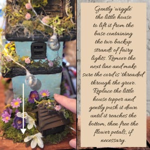 May include: A light blue miniature house decorated with moss, pink and purple flowers, and fairy lights. A white arrow points downward toward the base. Text instructions explain how to lift the house to access backup fairy light strands.