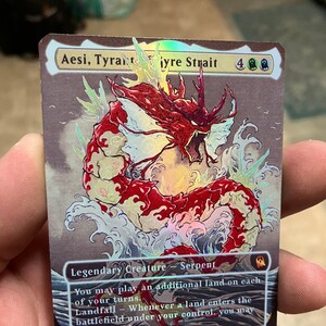 May include: Aesi, Tyrant of the Tygre Strait is a red and white creature with a serpentine body. It is a Magic: The Gathering card with a 4 mana cost and a 5/5 power and toughness. The card text reads: "Legendary Creature - Serpent. You may play an additional land on each of your turns. Landfall - Whenever a land enters the battlefield under your control, you may draw a card."