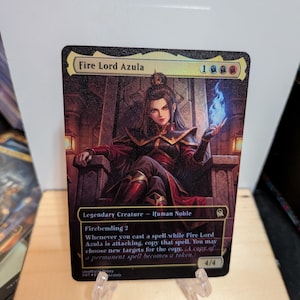 May include: A rectangular trading card titled Fire Lord Azula featuring a character sitting on a stone throne holding blue flames. The card text includes Legendary Creature - Human Noble, Firebending 2, and a 4/4 power and toughness rating.