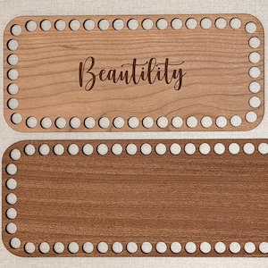 May include: Two rectangular wooden bases with rounded corners and evenly spaced holes along the perimeter. The top base features the engraved word Beautility in script font. A small square wooden tag displays the text TG CRAFT CO.