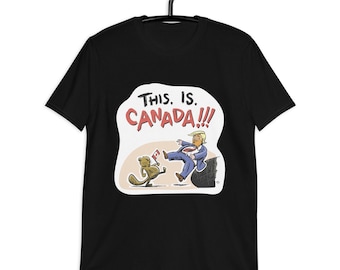 Puede incluir: Camiseta negra con un gráfico blanco de un castor de dibujos animados pateando a un hombre desde un acantilado. El gráfico dice "¡Esto es Canadá!!"