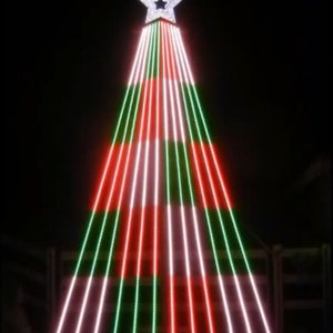 May include: A large outdoor Christmas tree made of lights. The tree is decorated with red, green, and white lights. The tree is topped with a white star.