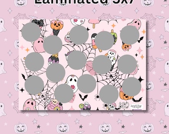 May include: A pink and white laminated 5x7 inch card with a Halloween theme. The card has a grid of 35 circles, each with a different Halloween-themed image, such as ghosts, pumpkins, bats, and spiders. The card also has the text "850" and "Janet Rae Budget" in the bottom right corner.
