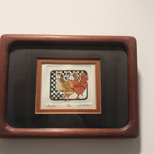 May include: A framed print of a colorful illustration of three chickens. The print is signed "Brenda" and "J. Walker".