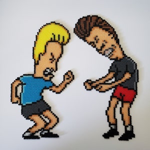 May include: Two pixel art figures of cartoon characters, one with blonde hair in a blue shirt and black shorts, the other with brown hair in a black shirt and red shorts. Both figures are in a confrontational pose, with their mouths open.