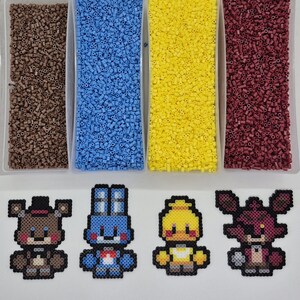 May include: An overhead shot shows four containers filled with brown, blue, yellow, and maroon beads. Below are four pixel art figures of a bear, a rabbit, a chick, and a fox, all in various colors. The figures are made from small beads.