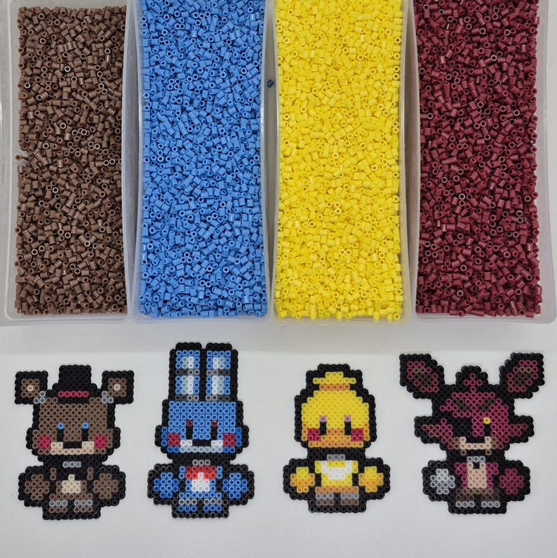 May include: An overhead shot shows four containers filled with brown, blue, yellow, and maroon beads. Below are four pixel art figures of a bear, a rabbit, a chick, and a fox, all in various colors. The figures are made from small beads.
