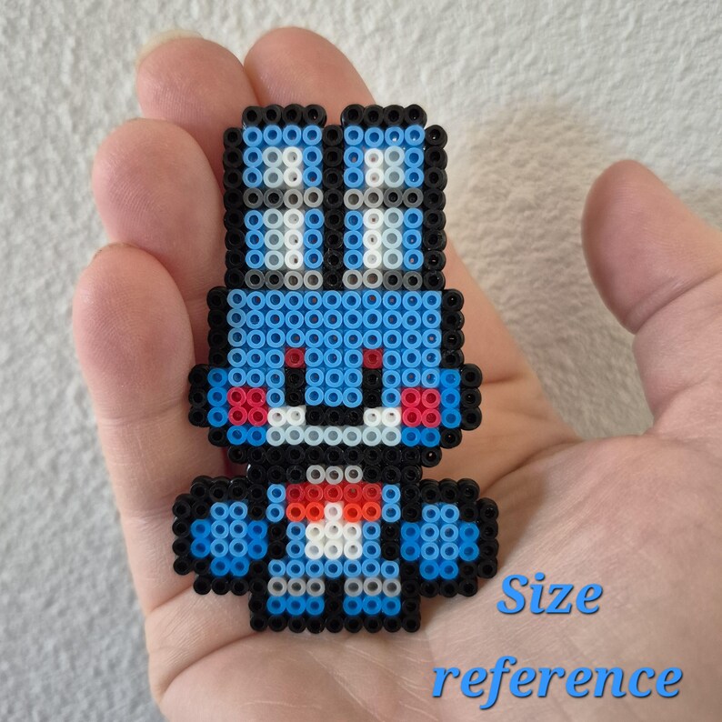 May include: A blue, black, red, and white pixel art character made of small beads. The character has a rabbit-like appearance with large ears and a small bow tie. The text "Size reference" is written in blue below the character.