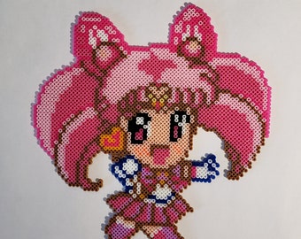 May include: A pixel art figure of a character with pink hair and a pink dress. The figure is made of small, colorful beads. The character has large eyes and is in a dynamic pose.