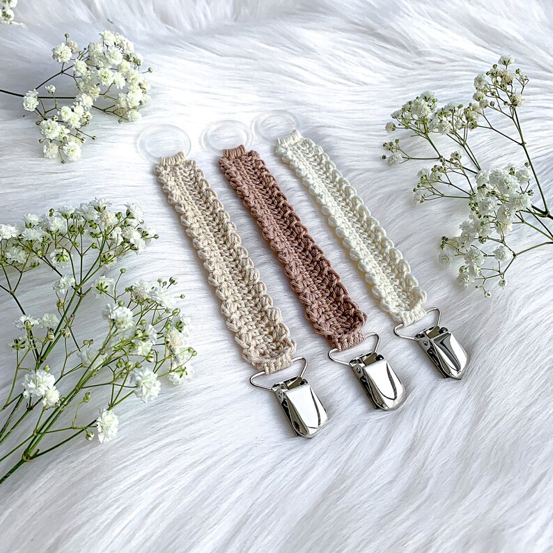Crochet pacifier clip Vera, pacifier holder, virkad napphållare/nappband, dummy clip, o-ring, binky holder, baby. Perfect handmade gift for new parents. Babyshower gift. Quick easy crochet pattern. Fast crochet project. Romantic, bibs. Animo design