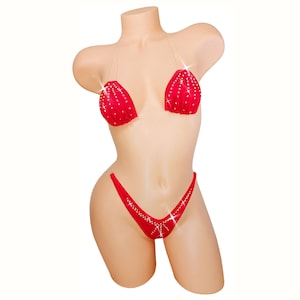 May include: Red bikini with clear straps and rhinestones. The top is a halter style and the bottom is a cheeky cut.