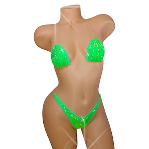 May include: A green bikini with clear straps and rhinestones. The top is a triangle style and the bottom is a cheeky cut.