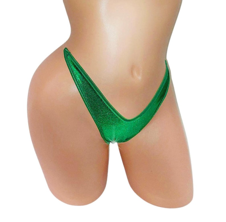 May include: A shiny, emerald green bikini bottom. The fabric has a metallic sheen, catching the light. The cut is a classic thong style, with a low rise and minimal coverage. The edges are cleanly finished, and the overall design is simple and sleek.