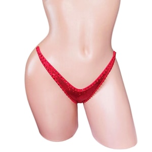 May include: Red sequined lingerie with a V-shaped front and a low-cut back.