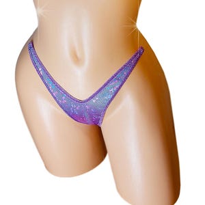 May include: Purple and blue glittery lingerie with a V-shaped front.