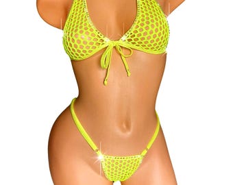 May include: Neon yellow bikini set. The halter top and thong-style bottom are made of a mesh fabric. The top has a tie closure and the edges are embellished with rhinestones. The bikini is displayed on a mannequin.