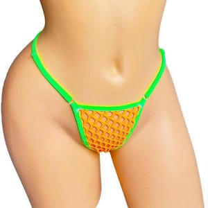 May include: Orange and green thong underwear. The underwear features a fishnet-style orange fabric for the front and back panels, with bright green trim along the edges and straps. The straps are thin and adjustable.