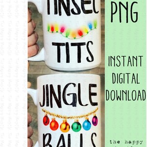 May include: Two white mugs with black text and Christmas-themed designs. The top mug says "Tinsel Tits" with a string of colourful lights. The bottom mug says "Jingle Balls" with a string of gold ornaments and colourful baubles.