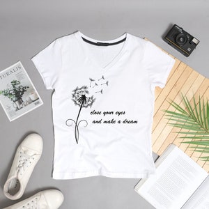 May include: White t-shirt with a black dandelion graphic and the text "Close your eyes and make a dream".