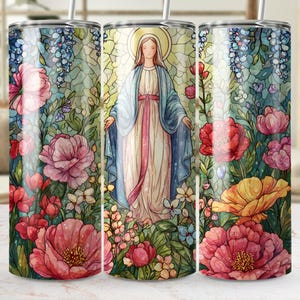 May include: A stainless steel tumbler featuring a watercolor illustration of a religious figure surrounded by flowers. The design includes a figure in a blue robe with a pink sash, set against a backdrop of colorful flowers and foliage.