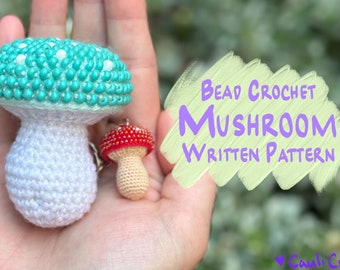 May include: A crochet mushroom with a teal and white cap and a white stem. A smaller red and white crochet mushroom is also shown. The text "Bead Crochet Mushroom Written Pattern" is written in purple on a yellow background.