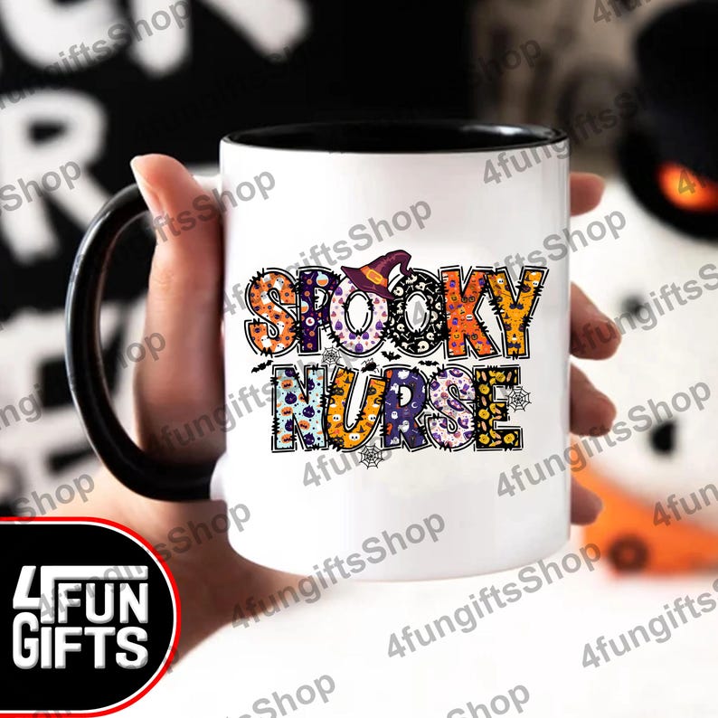 May include: White coffee mug with a black handle and black rim. The mug features a colourful design that says "Spooky Nurse" with a witch's hat on the "O" in "Spooky".