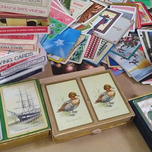 a large amount of different vintage playing cards, featured prominently are ships and ducks