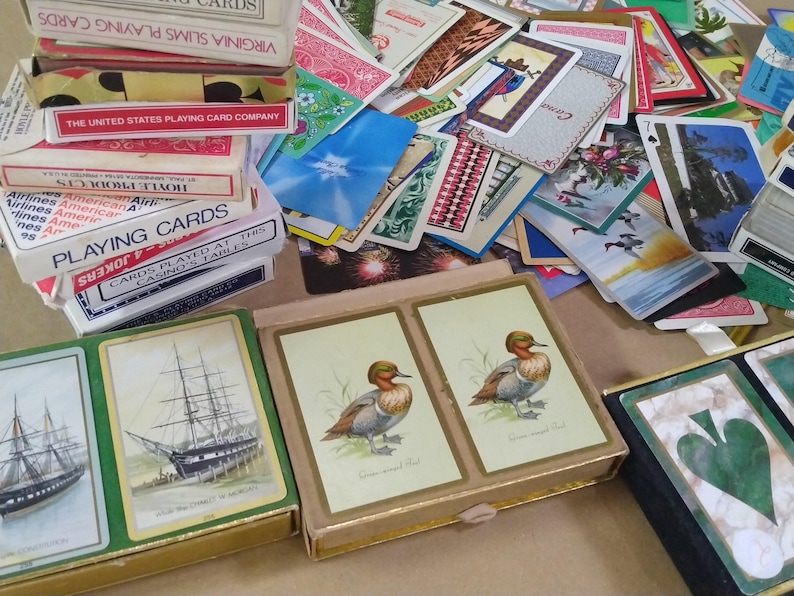a large amount of different vintage playing cards, featured prominently are ships and ducks