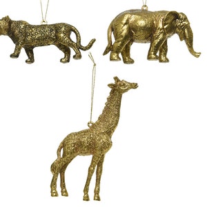 Könnte beinhalten: Drei goldfarbene Tierornamente: ein Tiger, ein Elefant und eine Giraffe. Die Ornamente sind aus glänzendem, metallischem Material gefertigt und haben ein detailliertes Design.