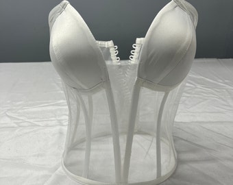 May include: White mesh corset with a satin bust and a hook and eye closure in the front.