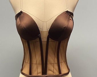 May include: A brown satin and mesh corset with a boned bodice and a sweetheart neckline.