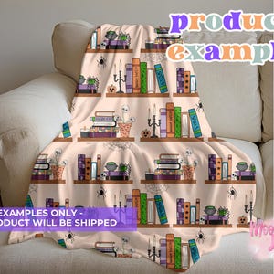 May include: A beige throw blanket featuring a repeating pattern of bookshelves with books, candles, skulls, and spiders. The blanket has the text "product example" and "EXAMPLES ONLY - NO PRODUCT WILL BE SHIPPED".
