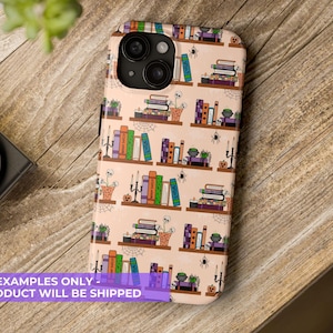 May include: A phone case with a repeating pattern of bookshelves, books, spiders, and pumpkins. The books are in various colors, and the shelves have small potted plants and candles. The case is peach-colored.