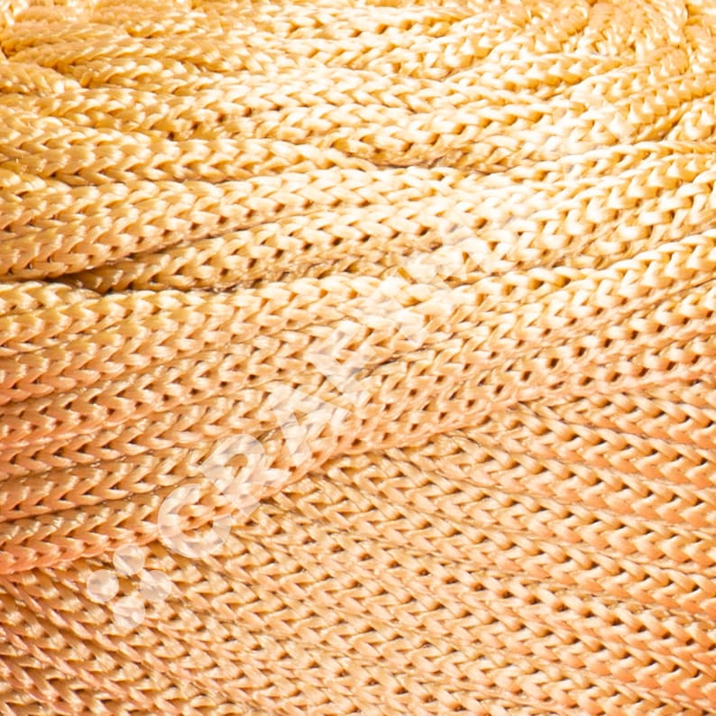 May include: Close-up of a woven rope made of a light brown material. The rope is tightly woven and has a smooth texture.
