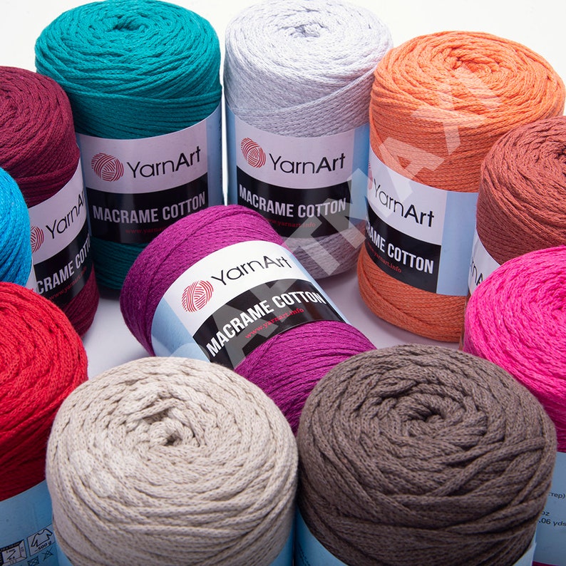 Op de afbeelding: Assortiment van kleurrijke katoenen garenbollen met het label "YarnArt Macrame Cotton".