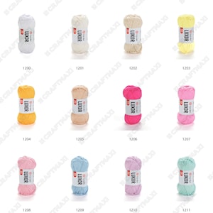 May include: Assortment of 11 skeins of yarn in various colors, including white, cream, yellow, pink, light blue, and green. Each skein is labeled "LUXOR" and has a number from 1200 to 1211.