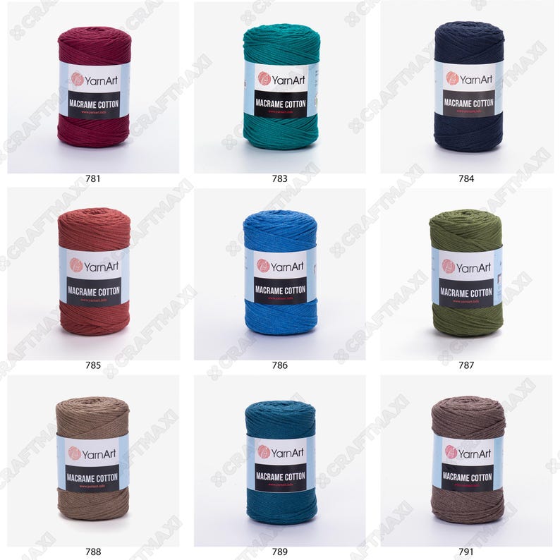 Op de afbeelding: Negen spoelen macram&eacute; katoenen garen in verschillende kleuren, waaronder rood, blauw, groen, bruin en grijs. Elke spoel is gelabeld met "YarnArt Macrame Cotton".