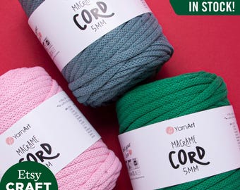 May include: Three spools of 5mm macrame cord in teal, pink, and green. The spools are labeled "YarnArt Macrame Cord 5mm". The text "ALL COLORS IN STOCK!" is in a green box.