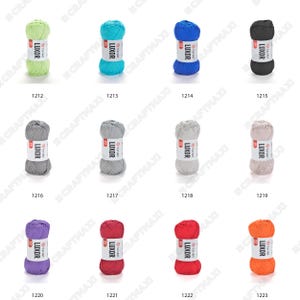 May include: Assortment of 10 balls of yarn in various colors, including green, blue, black, gray, pink, purple, red, and orange. Each ball is labeled with the brand name "LUXOR" and a number.